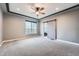 Cozy bedroom features neutral carpeting, modern ceiling fan, and a window with views of the neighborhood at 5506 Malta St, Denver, CO 80249