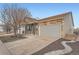 Charming home with stone and siding, landscaped yard, and a spacious driveway leading to an attached garage at 5506 Malta St, Denver, CO 80249