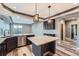 Modern kitchen features an island with a marble countertop, stainless steel appliances, and stylish pendant lighting at 5506 Malta St, Denver, CO 80249