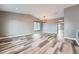 Bright living room featuring high ceilings, neutral paint, recessed lights, and unique gray flooring at 5506 Malta St, Denver, CO 80249