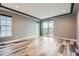 A large living room with neutral paint, recessed ceiling lights, and access to an outdoor patio at 5506 Malta St, Denver, CO 80249