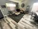 Comfortable living room with stylish gray floors, a cozy seating area, and natural light from the windows at 5506 Malta St, Denver, CO 80249