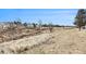 View of the homes in the community along the walking trail with open land and blue skies at 17493 E Mansfield Ave # 1231L, Aurora, CO 80013