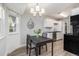Dining area with view and light floors is conveniently located near kitchen at 17493 E Mansfield Ave # 1231L, Aurora, CO 80013