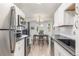 Open-concept kitchen features stainless steel appliances and light floors connects to dining area at 17493 E Mansfield Ave # 1231L, Aurora, CO 80013