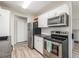 Modern kitchen with stainless steel appliances, white cabinets, and light floors at 17493 E Mansfield Ave # 1231L, Aurora, CO 80013