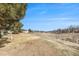 Open field landscape with scattered trees and neighborhood buildings on the horizon at 17493 E Mansfield Ave # 1231L, Aurora, CO 80013