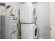 Laundry area including stacked washer and dryer and a hot water heater at 17493 E Mansfield Ave # 1231L, Aurora, CO 80013