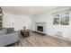 Cozy living room with stone fireplace, large window for natural light, and neutral paint at 17493 E Mansfield Ave # 1231L, Aurora, CO 80013
