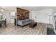 Inviting living room features wood accent wall, neutral paint, and light floors at 17493 E Mansfield Ave # 1231L, Aurora, CO 80013
