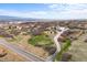 An aerial view shows a long driveway that goes to the house and a street nearby at 3074 Castle Butte Dr, Castle Rock, CO 80109
