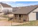 A tan barn with horse stalls opening to the pasture at 3074 Castle Butte Dr, Castle Rock, CO 80109