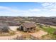A tan barn with brown trim is seen with a dirt area surrounding it at 3074 Castle Butte Dr, Castle Rock, CO 80109