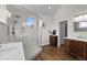 Bathroom featuring a glass-enclosed shower, wood vanity, and double sinks at 3074 Castle Butte Dr, Castle Rock, CO 80109
