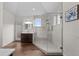 Modern bathroom with a glass enclosed shower, wood vanity, and tile accents at 3074 Castle Butte Dr, Castle Rock, CO 80109