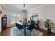 Bright dining room featuring a round table, seating for six, and modern decor at 3074 Castle Butte Dr, Castle Rock, CO 80109