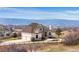 Stately stucco home featuring grand architecture and breathtaking mountain views, set amidst a serene landscape at 3074 Castle Butte Dr, Castle Rock, CO 80109