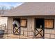 A gray and a brown horse peer out from their wooden stalls at 3074 Castle Butte Dr, Castle Rock, CO 80109