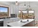 Gourmet kitchen with scenic views, a center island with cooktop, and sleek countertops at 3074 Castle Butte Dr, Castle Rock, CO 80109