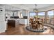 Bright eat-in kitchen features an island, stainless appliances, modern pendant lights, and an adjacent dining area at 3074 Castle Butte Dr, Castle Rock, CO 80109