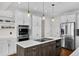 Well-equipped kitchen with a center island, built-in oven, stainless steel appliances, and ample storage at 3074 Castle Butte Dr, Castle Rock, CO 80109