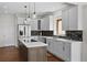 Modern kitchen with stainless steel appliances, quartz countertops, an island, and stylish pendant lighting at 3074 Castle Butte Dr, Castle Rock, CO 80109
