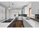 Bright and airy kitchen featuring white cabinets, a center island with cooktop, and stainless steel appliances at 3074 Castle Butte Dr, Castle Rock, CO 80109