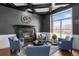Elegant living room with a fireplace, coffered ceiling, and comfortable seating arrangement at 3074 Castle Butte Dr, Castle Rock, CO 80109