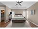 Cozy main bedroom with a king-size bed, hardwood floors, and natural light from large windows at 3074 Castle Butte Dr, Castle Rock, CO 80109
