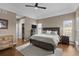 Spacious main bedroom with hardwood floors, ceiling fan and tray ceiling detail at 3074 Castle Butte Dr, Castle Rock, CO 80109