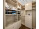 Organized walk-in closet with custom shelving, drawers, and ample storage space at 3074 Castle Butte Dr, Castle Rock, CO 80109