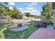 Backyard featuring a hot tub and patio with seating, surrounded by luscious plants and trees at 6987 Esperanza Dr, Castle Pines, CO 80108
