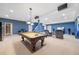 Finished basement with carpet, pool table, TV, bar seating and entertainment area at 6987 Esperanza Dr, Castle Pines, CO 80108