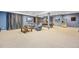 Finished basement with carpet, curtains, two TVs, refridgerator, and two lounge chairs at 6987 Esperanza Dr, Castle Pines, CO 80108