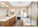 Bright primary bathroom featuring dual sinks, soaking tub and glass shower at 6987 Esperanza Dr, Castle Pines, CO 80108
