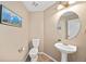 A cozy half bathroom with tile floors, a pedestal sink and attractive lighting at 6987 Esperanza Dr, Castle Pines, CO 80108