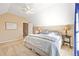 A bedroom with vaulted ceiling, fan, neutral walls and soft carpeting at 6987 Esperanza Dr, Castle Pines, CO 80108