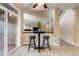 Cozy dining area with tiled floors and bar seating, perfect for casual meals and gatherings at 6987 Esperanza Dr, Castle Pines, CO 80108