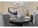 Close up of the dining table setting and decorations with a modern chandelier at 6987 Esperanza Dr, Castle Pines, CO 80108