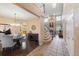 Elegant dining room featuring chandelier, hardwood floors, and easy access to the staircase at 6987 Esperanza Dr, Castle Pines, CO 80108
