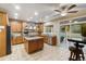 Spacious kitchen boasts custom cabinets, stainless steel appliances, granite countertops, and a center island at 6987 Esperanza Dr, Castle Pines, CO 80108