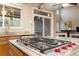 This kitchen features a wolf gas range, granite countertops, and a window with a sink at 6987 Esperanza Dr, Castle Pines, CO 80108