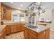 Gourmet kitchen featuring granite countertops, custom cabinets, a center island, and stainless steel appliances at 6987 Esperanza Dr, Castle Pines, CO 80108