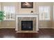 A cozy fireplace with a decorative mantel and marble surround creates a warm focal point in the room at 6987 Esperanza Dr, Castle Pines, CO 80108