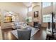 A spacious living room with vaulted ceilings, a fireplace, and hardwood floors offers a comfortable and inviting space at 6987 Esperanza Dr, Castle Pines, CO 80108