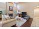 Cozy living room showcasing comfortable seating, a fireplace, hardwood floors, and contemporary décor at 6987 Esperanza Dr, Castle Pines, CO 80108