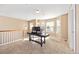 A bright loft area with neutral carpet is staged as a home office with built in speakers and lots of natural light at 6987 Esperanza Dr, Castle Pines, CO 80108