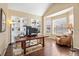 A sun-filled office featuring hardwood floors, custom bookshelves, and a bay window provides a productive workspace at 6987 Esperanza Dr, Castle Pines, CO 80108