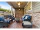 Covered patio with furniture and view of fenced backyard with brick and wood support columns at 6987 Esperanza Dr, Castle Pines, CO 80108