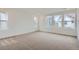 Sunny bedroom featuring neutral carpeting, large windows, and ample natural light at 7199 Waterleaf Trl, Littleton, CO 80125